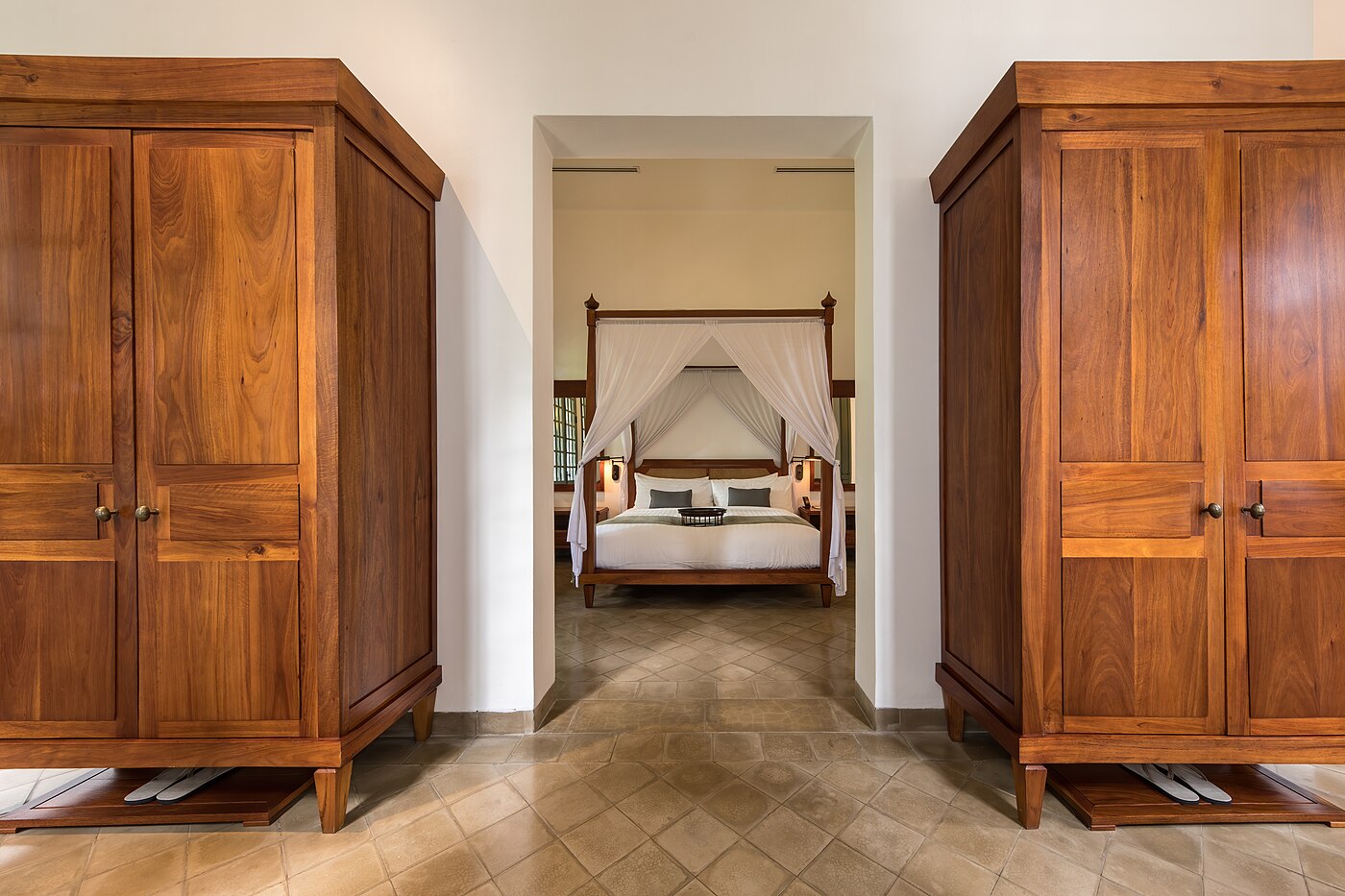 Canopy bed and wardrobes in Khan Pool Suite at Amantaka luxury Resort & Hotel in Luang Prabang Laos