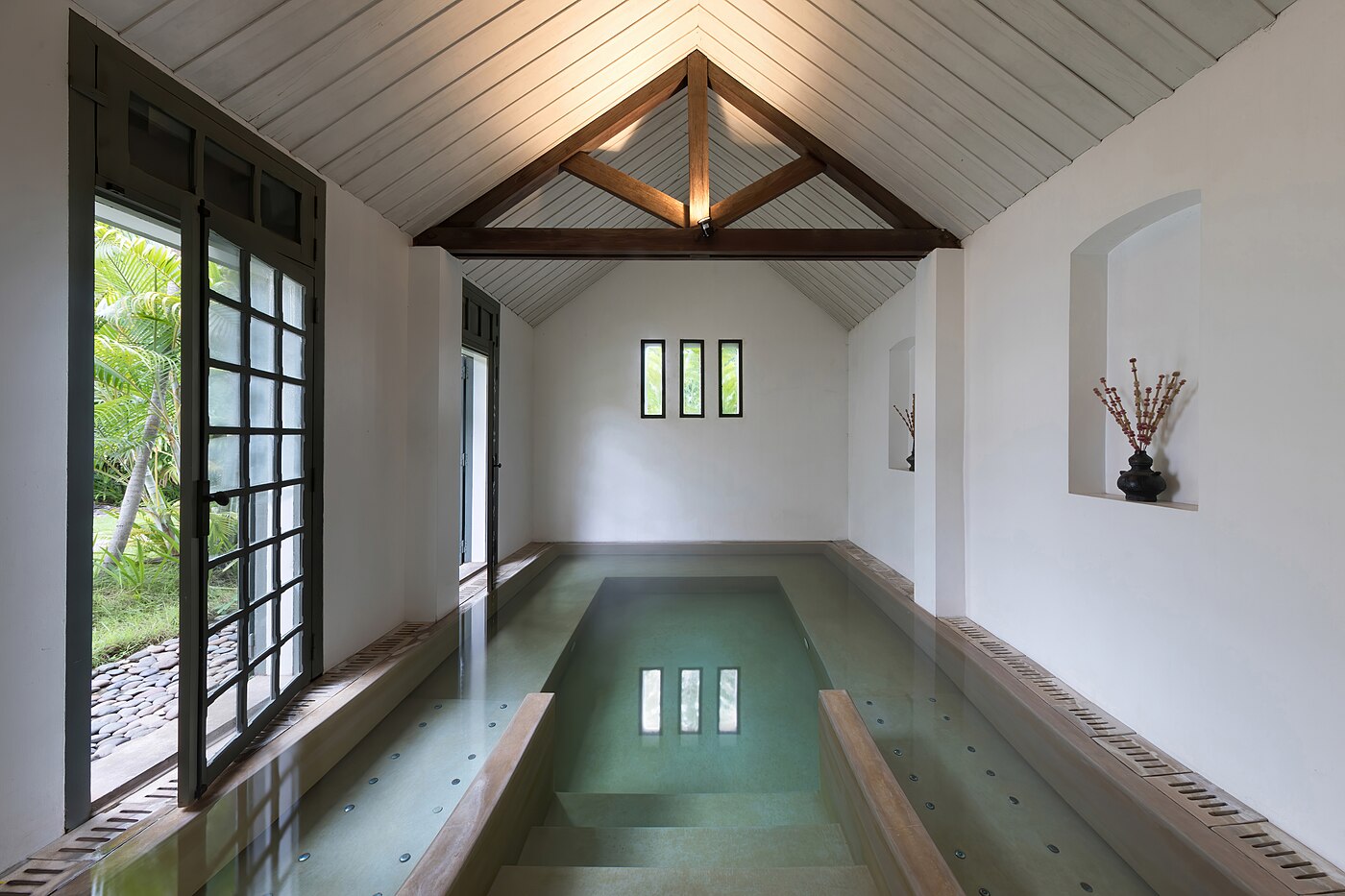 Indoor pool of spa with open door at Amantaka luxury Resort & Hotel in Luang Prabang Laos