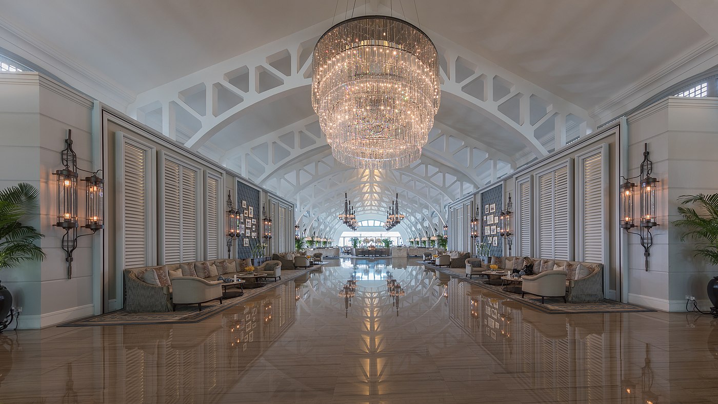 Symmetric view lobby hall with couches and chandelier at The Fullerton Bay Hotel Singapore