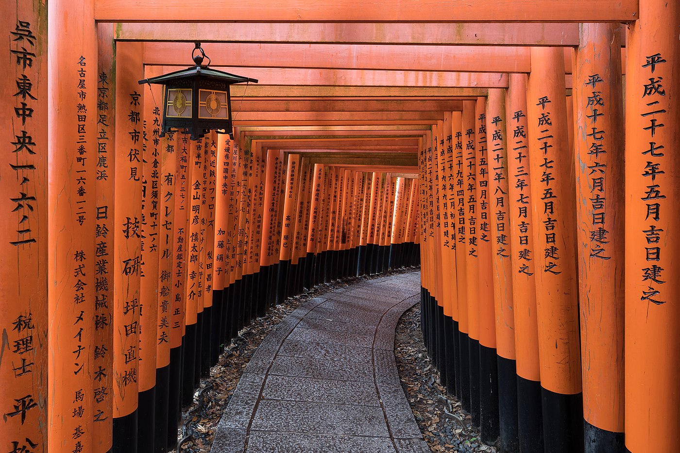 Torii path with a hanging lantern at Fushimi Inari Taisha Shrine Senbontorii Kyoto