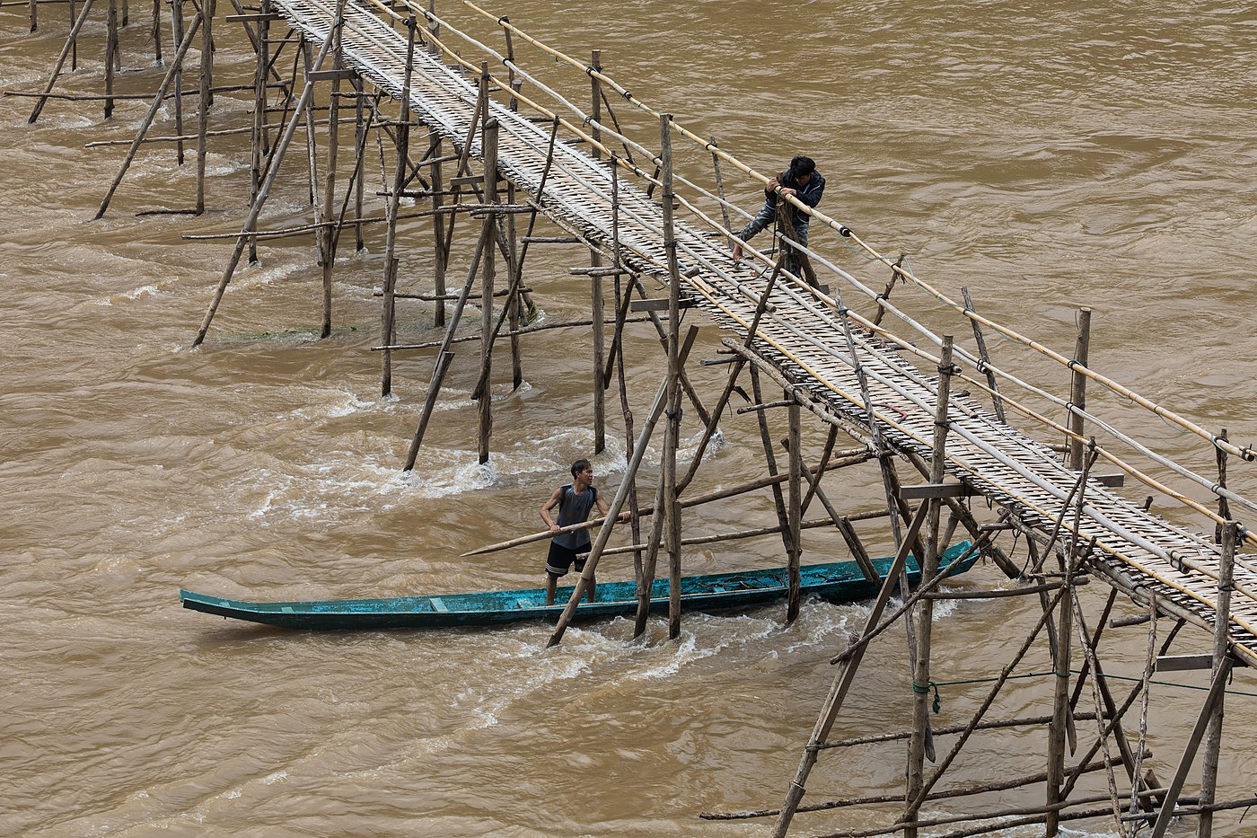 wooden footbridge with workers working Mekong