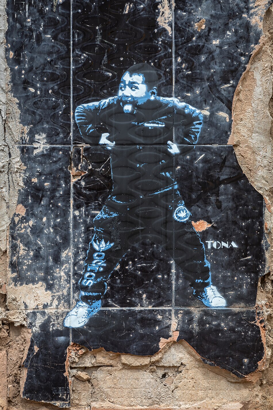 Street art stencil painting of a standing girl with crossed arms on black tiles by German artist Tona in Vientiane Laos